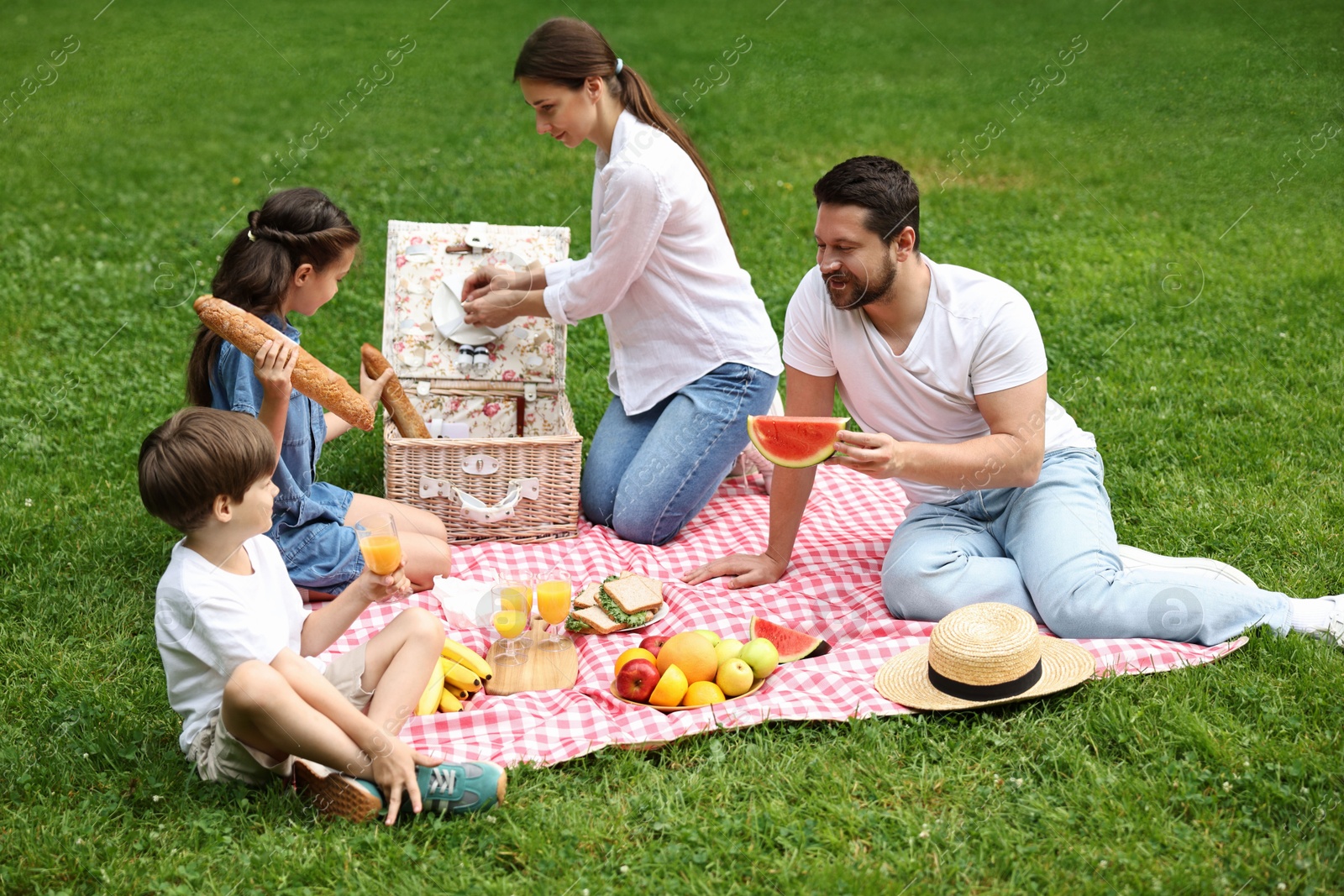 Photo of Lovely family having picnic together in park