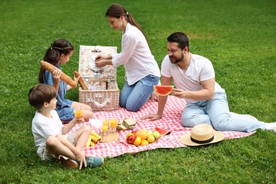 Lovely family having picnic together in park