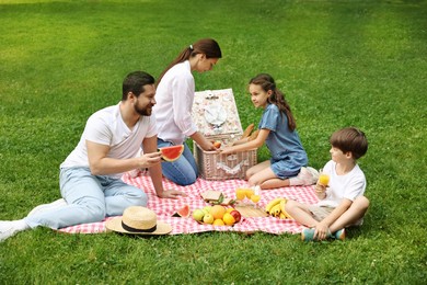 Photo of Lovely family having picnic together in park