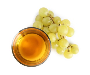 Photo of Tasty juice in glass and fresh grapes isolated on white, top view