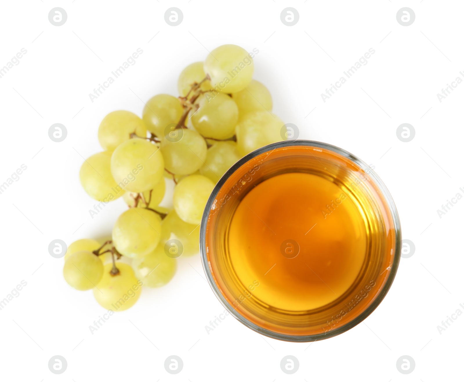 Photo of Tasty juice in glass and fresh grapes isolated on white, top view