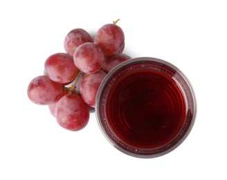 Tasty juice in glass and grapes isolated on white, top view