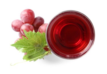 Tasty grape juice in glass, leaf and berries isolated on white, top view