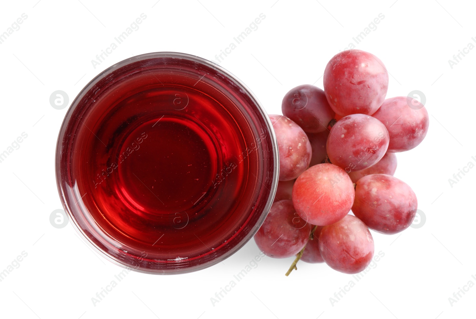 Photo of Tasty grape juice in glass and berries isolated on white, top view