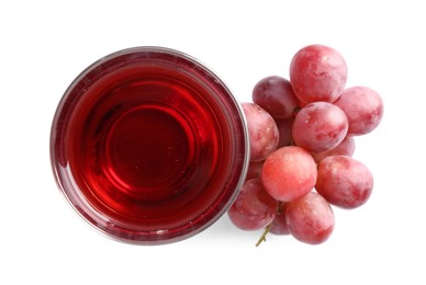 Photo of Tasty grape juice in glass and berries isolated on white, top view