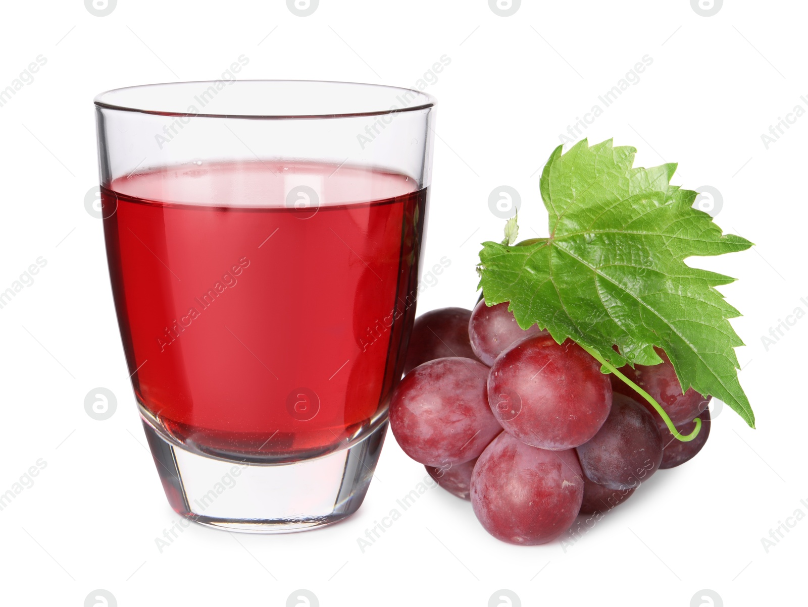 Photo of Tasty grape juice in glass, leaf and berries isolated on white