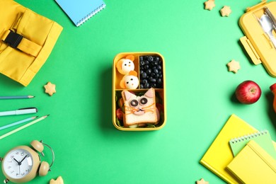 Photo of Flat lay composition with lunch box and snacks on green table