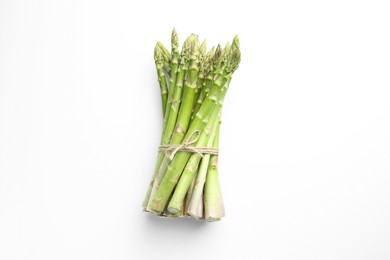 Photo of Bunch of fresh green asparagus stems on white table, top view