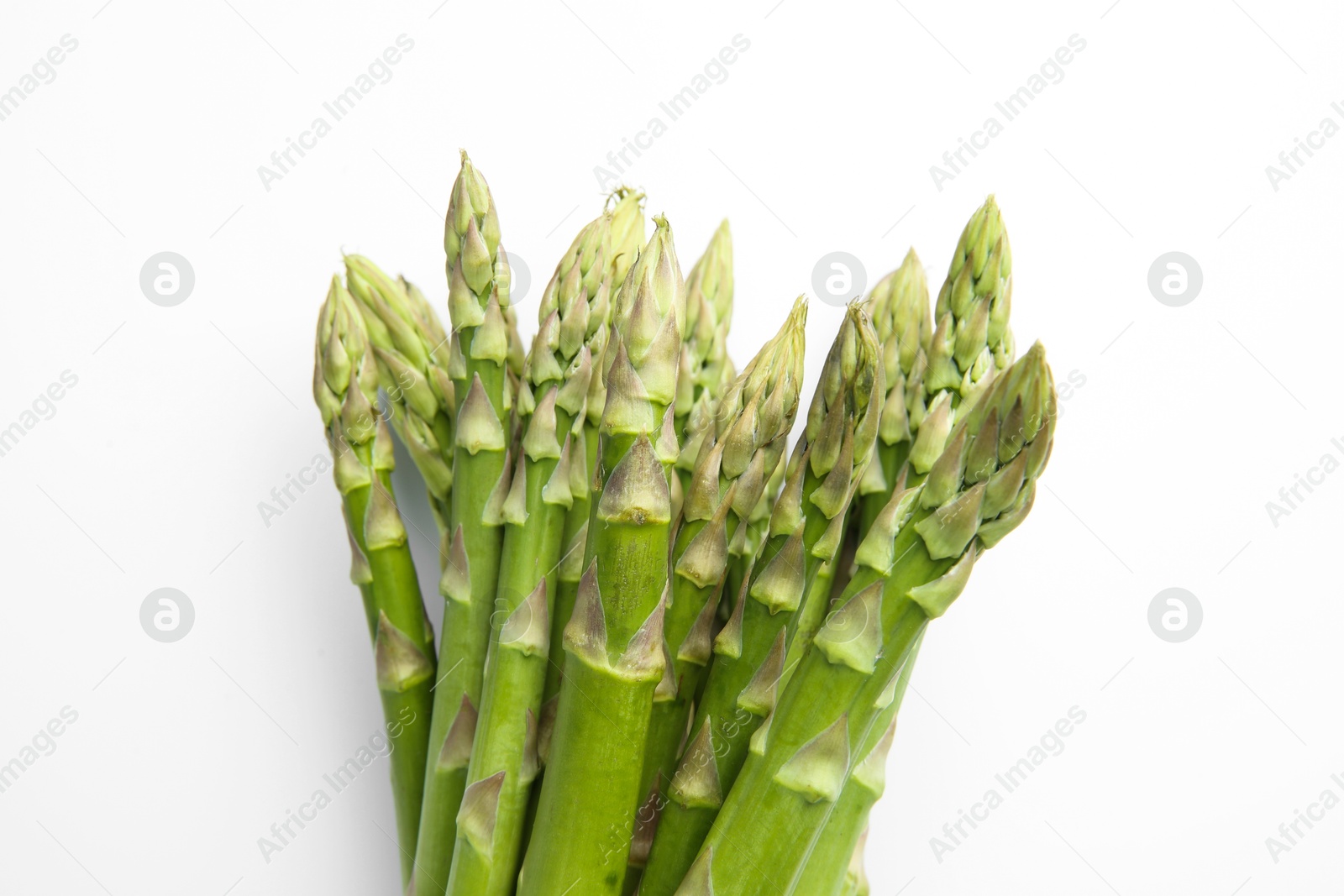 Photo of Fresh green asparagus stems on white table, top view