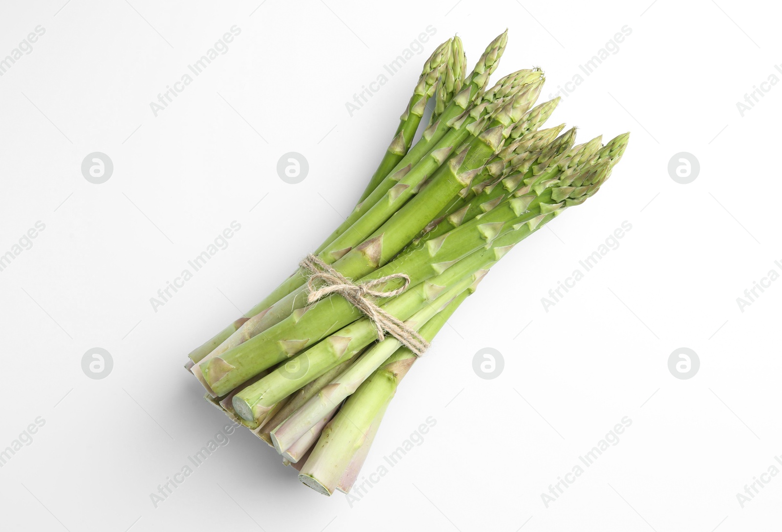 Photo of Bunch of fresh green asparagus stems on white table, top view