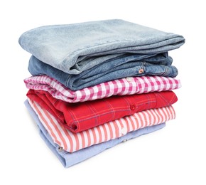 Photo of Stack of shirts and jeans isolated on white