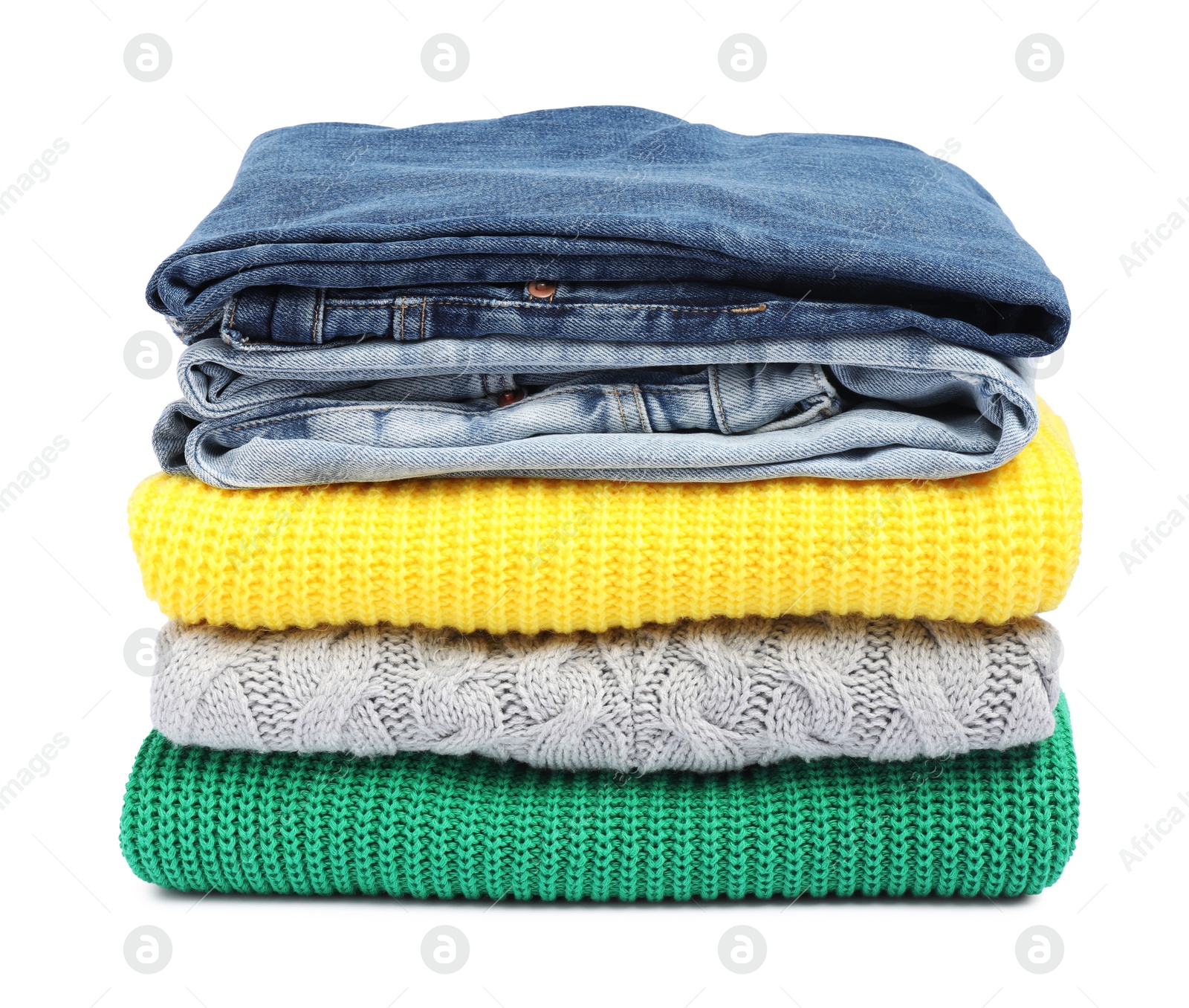 Photo of Stack of sweaters and jeans isolated on white