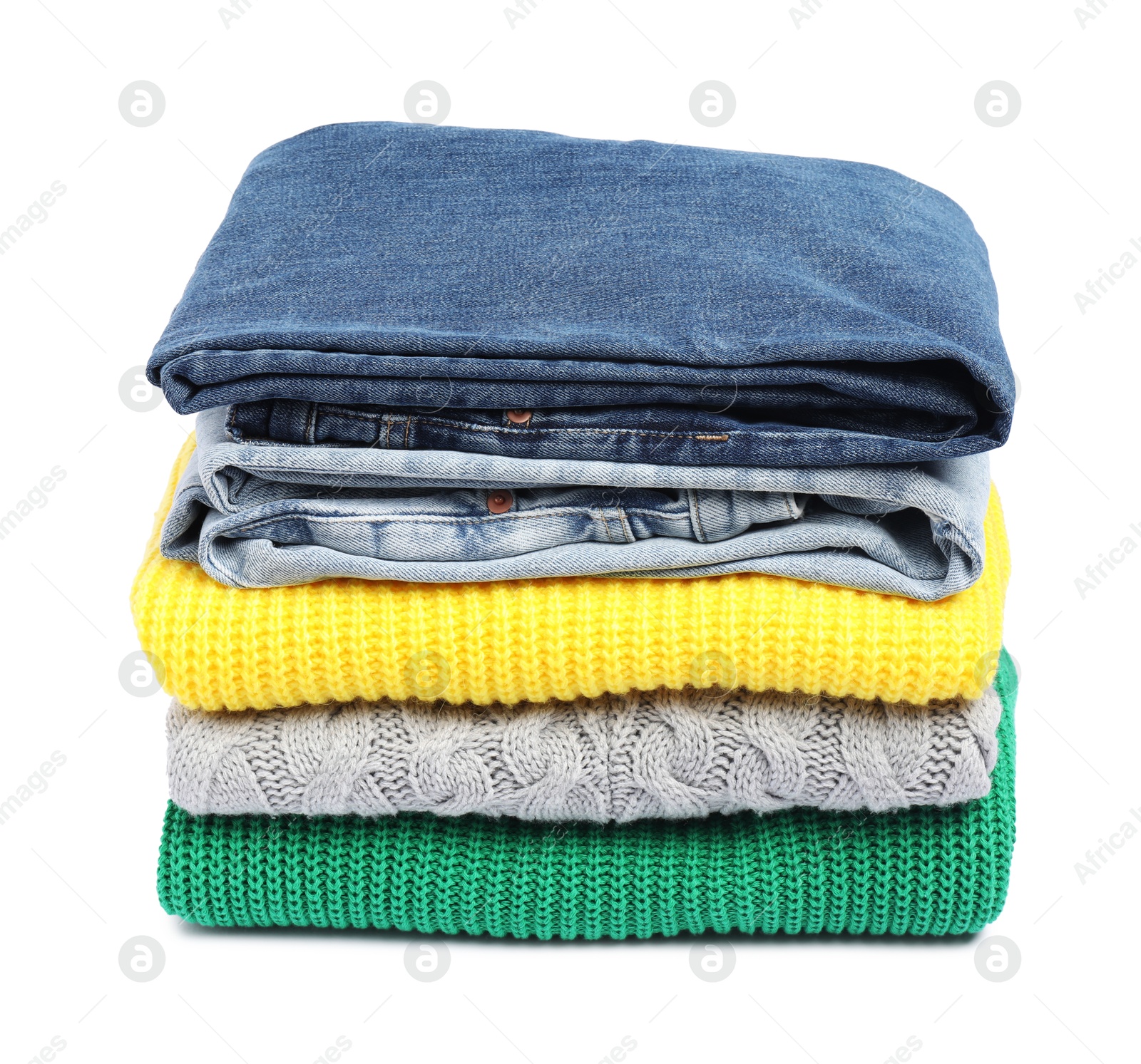 Photo of Stack of sweaters and jeans isolated on white