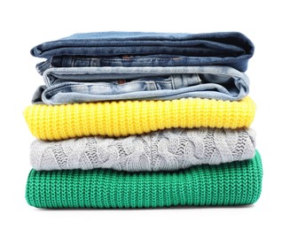 Photo of Stack of sweaters and jeans isolated on white