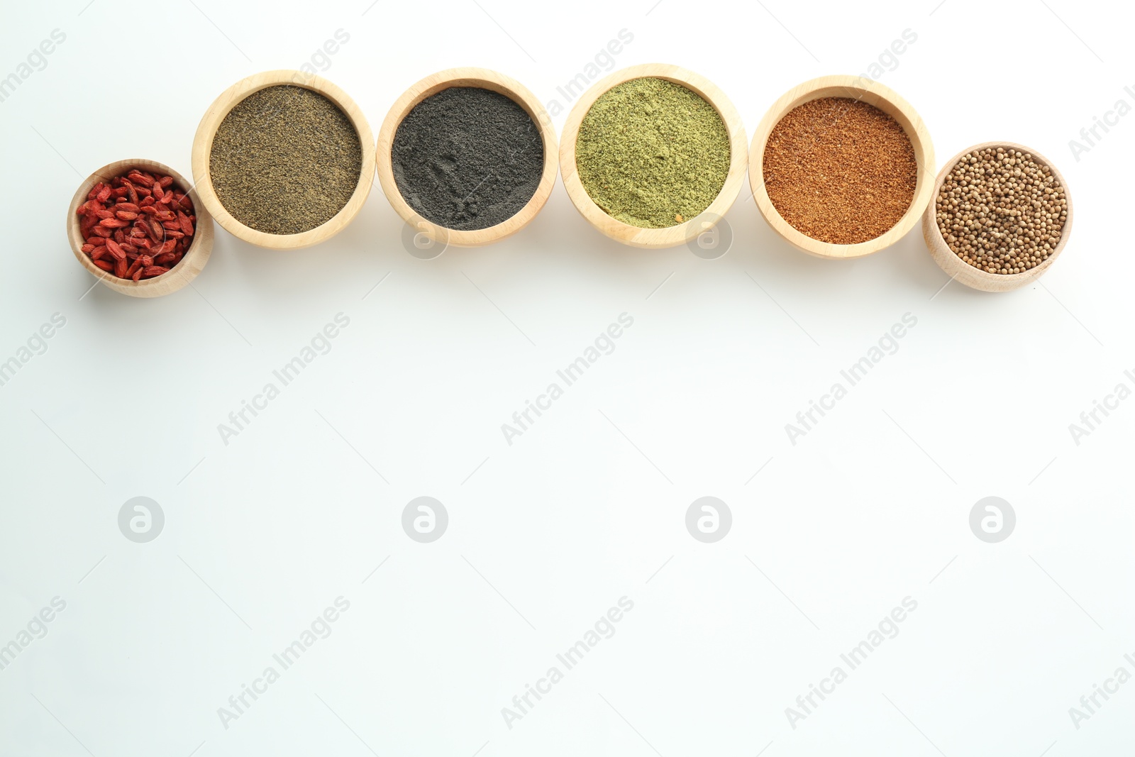 Photo of Different superfood powders in bowls on white background, flat lay. Space for text