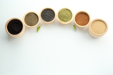 Photo of Different superfood powders in bowls on white background, flat lay. Space for text