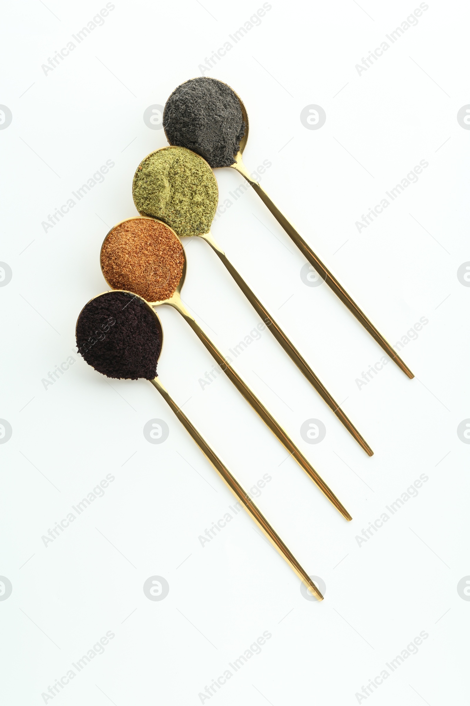 Photo of Spoons with different superfood powders on white background, flat lay