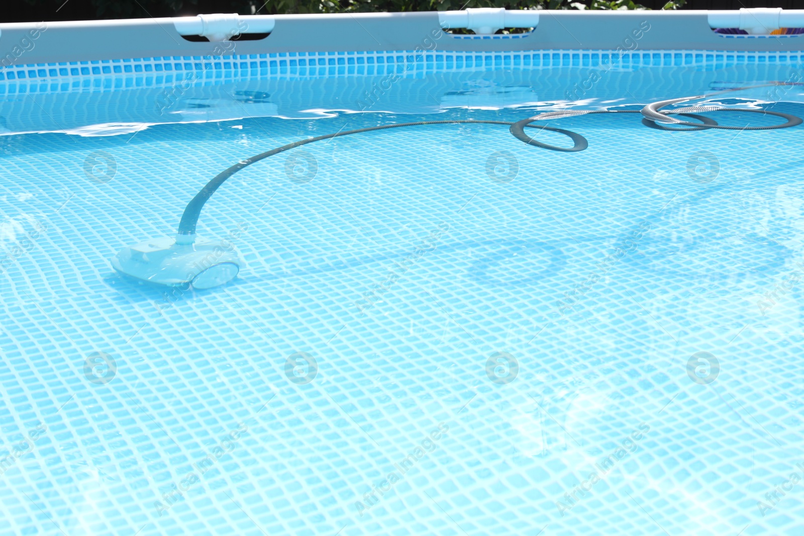 Photo of One robotic cleaner in swimming pool outdoors