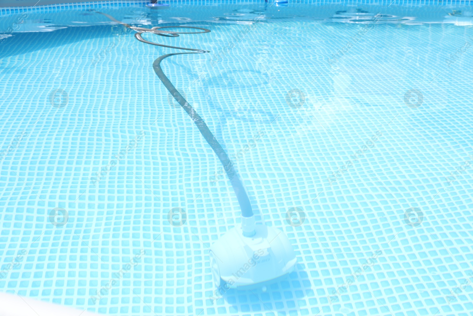 Photo of One robotic cleaner in swimming pool outdoors