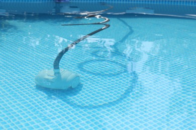 Photo of One robotic cleaner in swimming pool outdoors