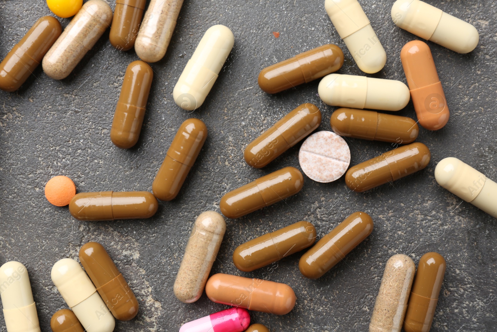 Photo of Pharmacist. Different pills on grey table, flat lay