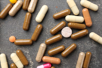 Photo of Pharmacist. Different pills on grey table, flat lay