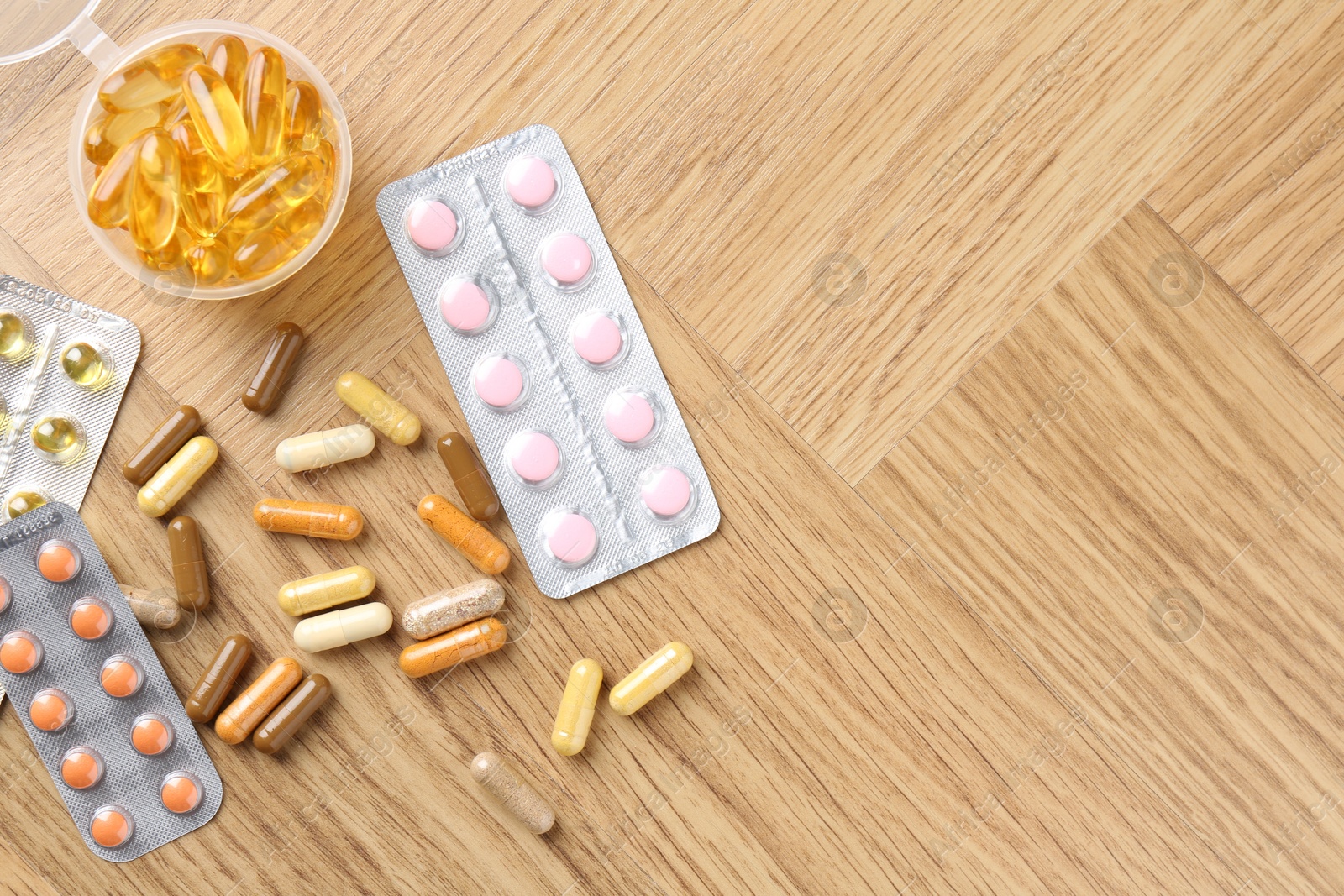 Photo of Pharmacist. Different pills on wooden table, flat lay. Space for text