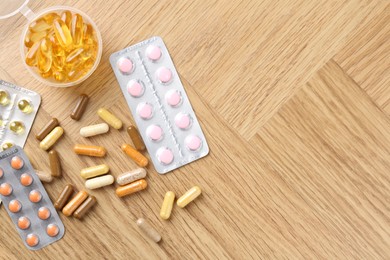 Photo of Pharmacist. Different pills on wooden table, flat lay. Space for text