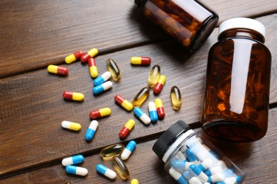 Pharmacist. Different pills and plastic bottles on wooden table