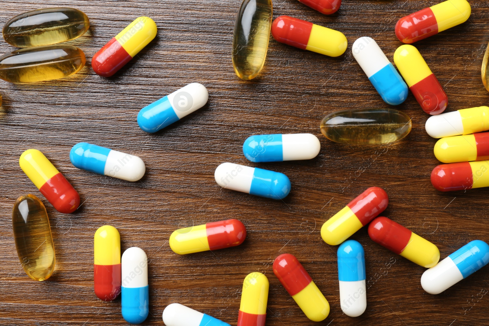 Photo of Pharmacist. Different pills on wooden table, flat lay