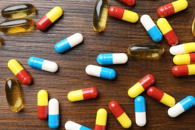 Pharmacist. Different pills on wooden table, flat lay