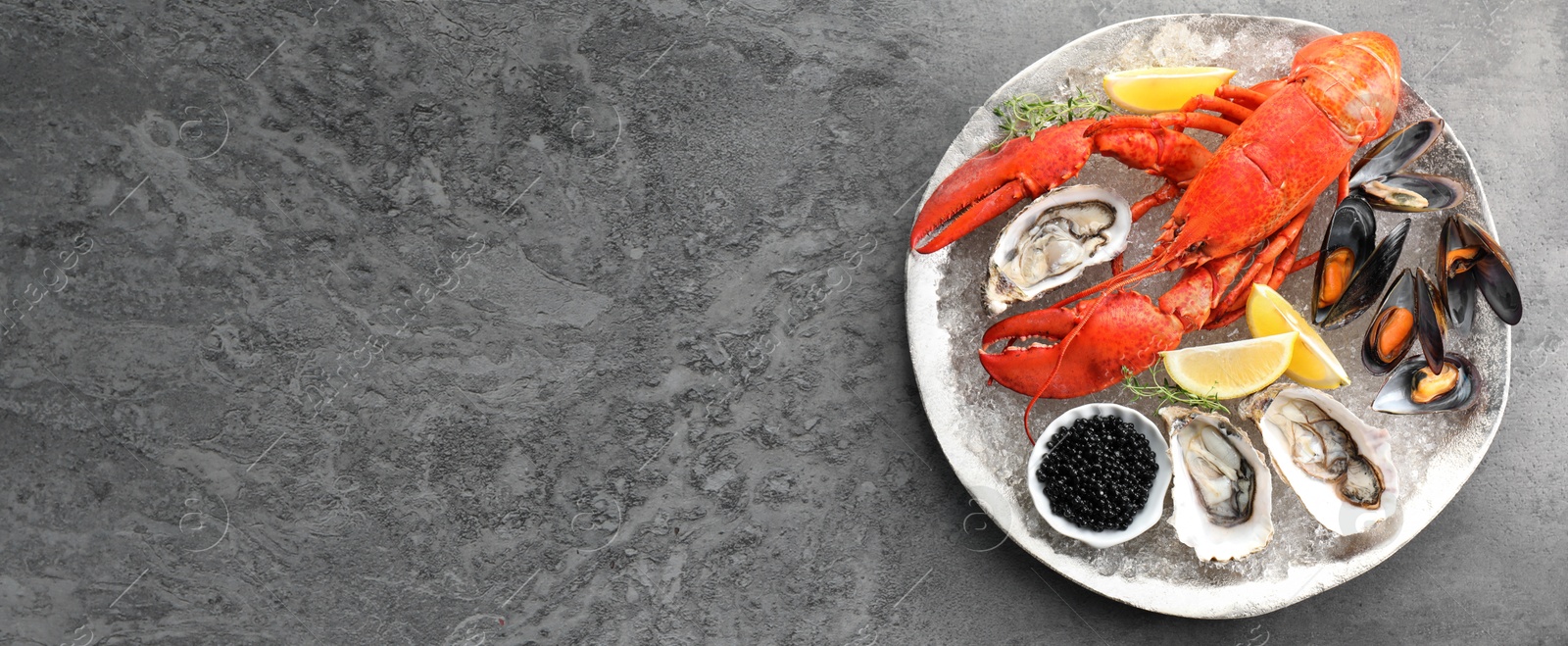 Image of Many different fresh sea food on grey table, flat lay. Banner design with space for text