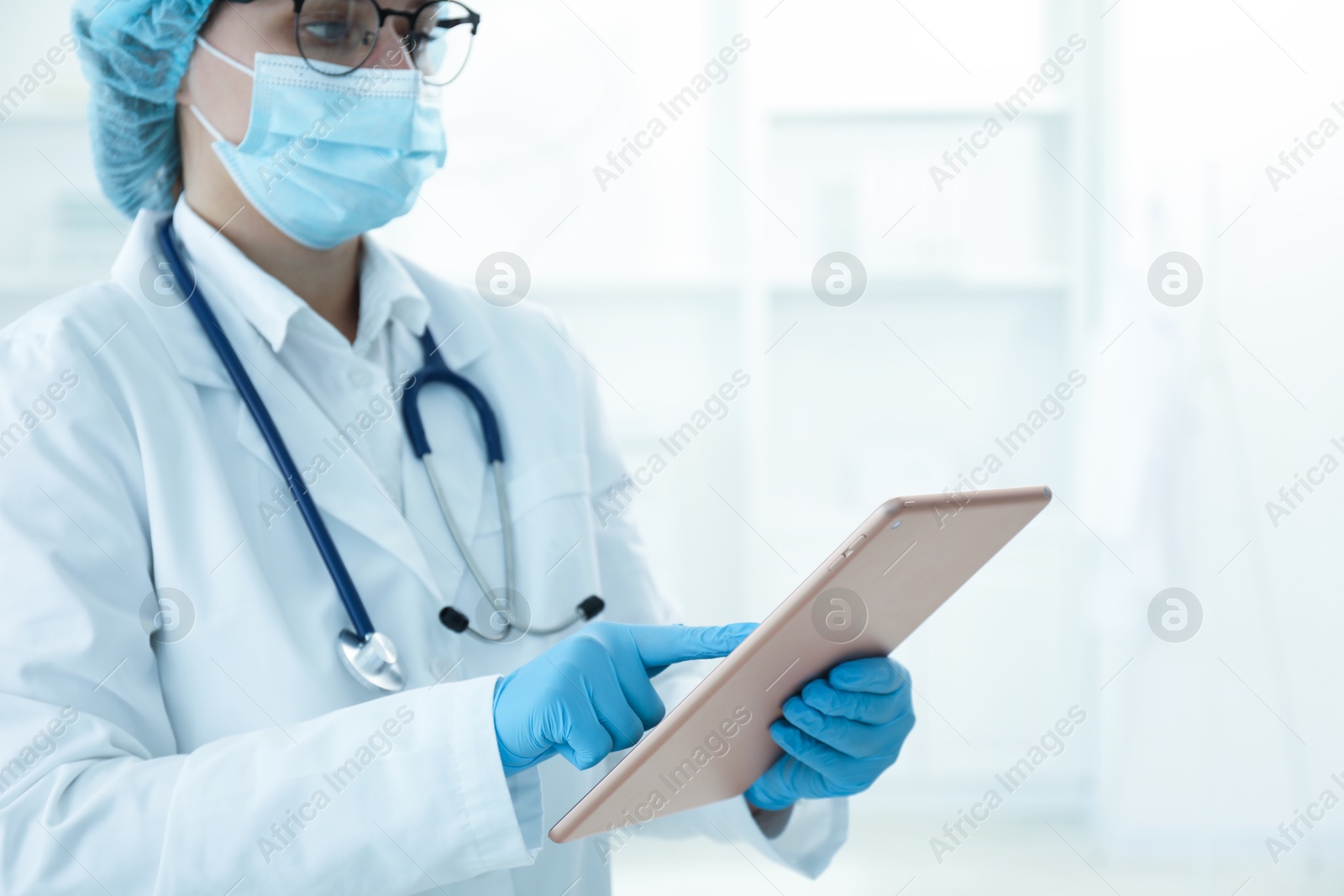 Photo of Doctor with tablet in clinic, closeup view