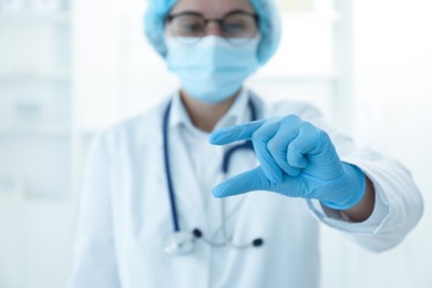 Photo of Doctor holding something in clinic, selective focus. Space for text