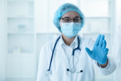 Doctor holding something in clinic, selective focus. Space for text