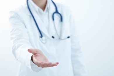 Doctor holding something on white background, closeup