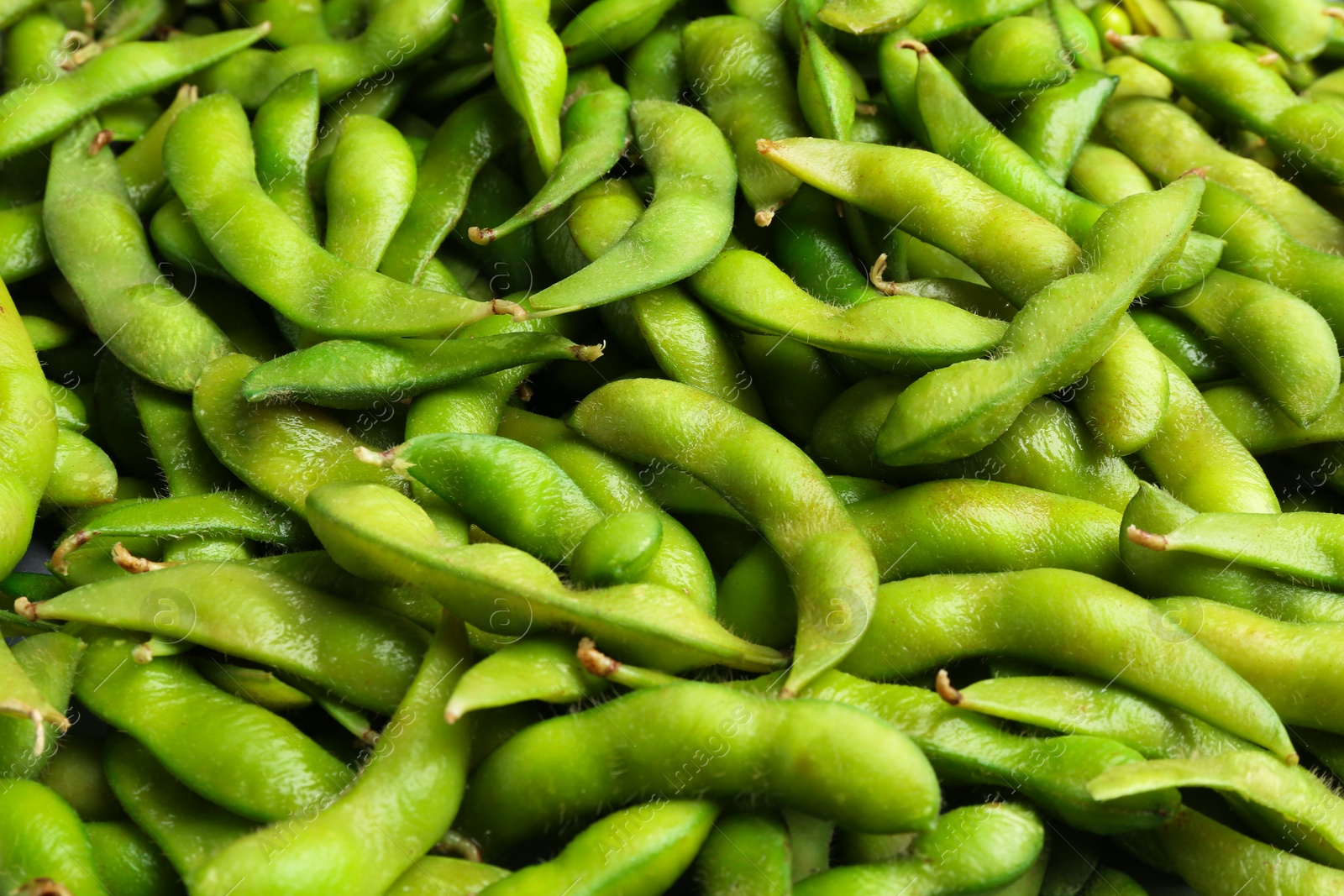 Photo of Fresh edamame pods as background, closeup view