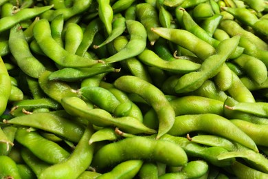 Photo of Fresh edamame pods as background, closeup view