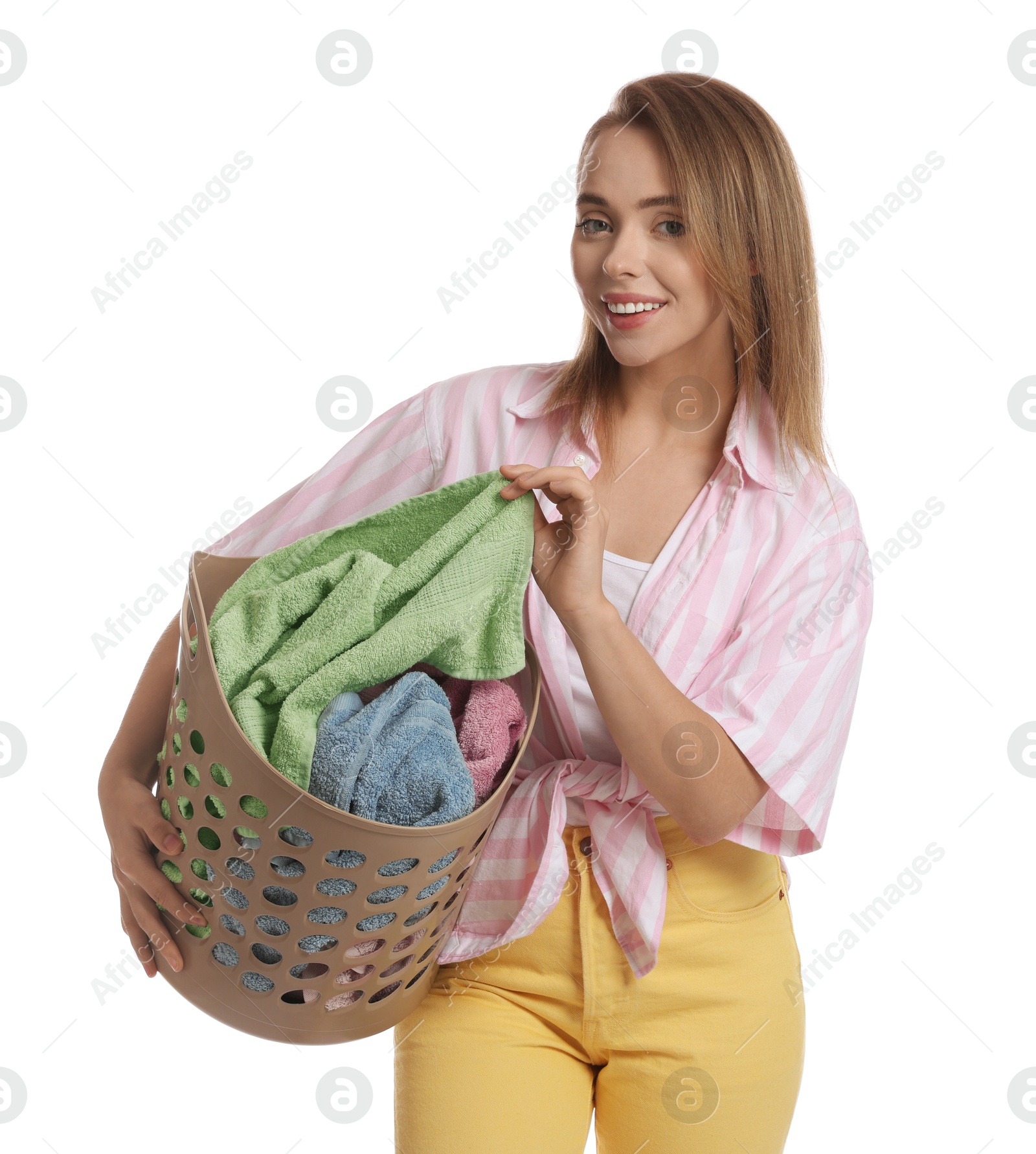 Photo of Happy young housewife with basket full of laundry on white background