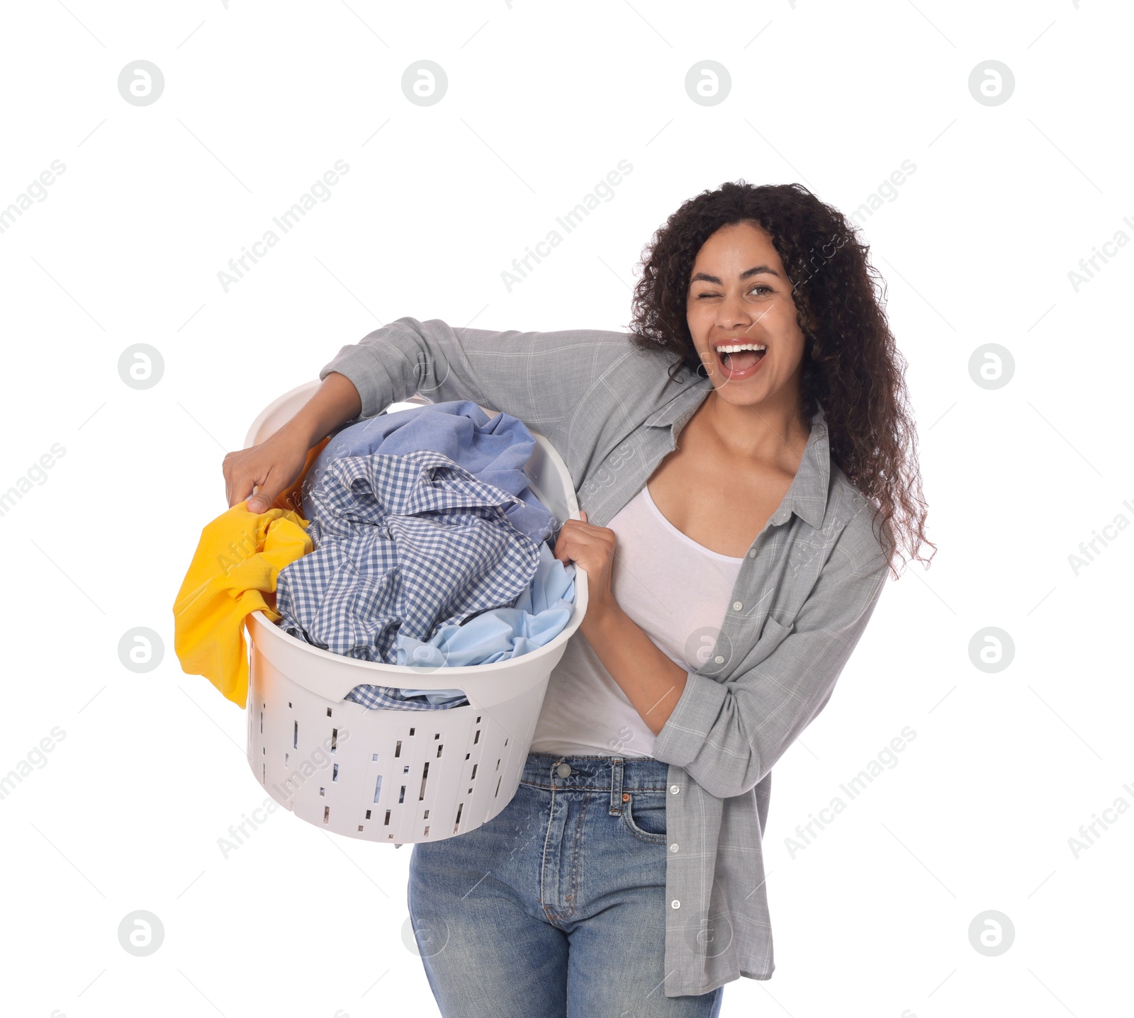 Photo of Happy woman with basket full of laundry on white background