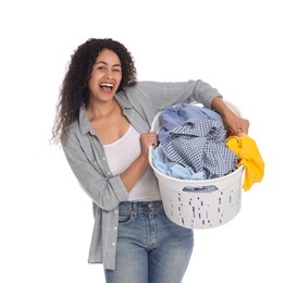 Happy woman with basket full of laundry on white background