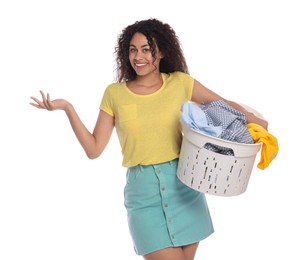 Photo of Happy woman with basket full of laundry on white background