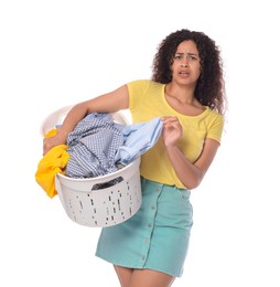 Photo of Displeased woman with basket full of laundry on white background