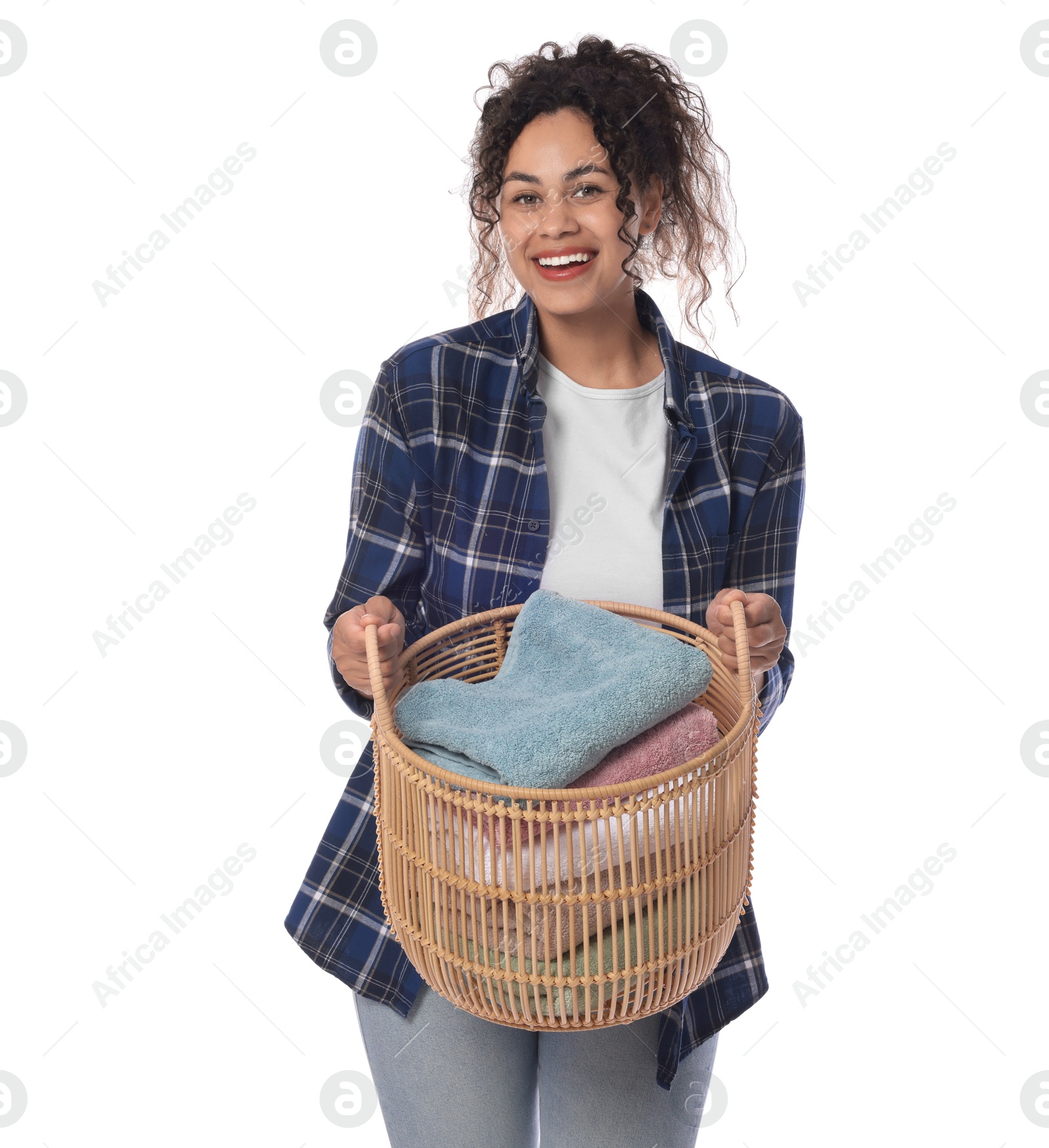 Photo of Happy woman with basket full of laundry on white background