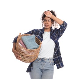 Photo of Tired woman with basket full of laundry on white background