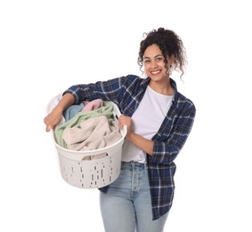 Happy woman with basket full of laundry on white background