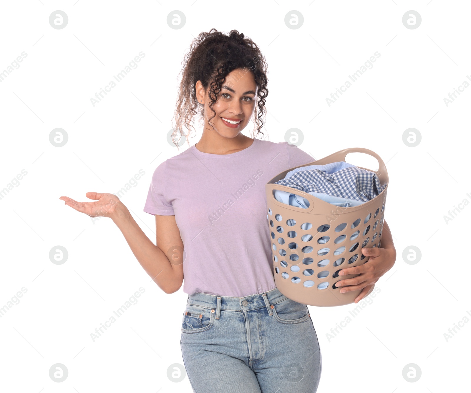 Photo of Happy woman with basket full of laundry on white background