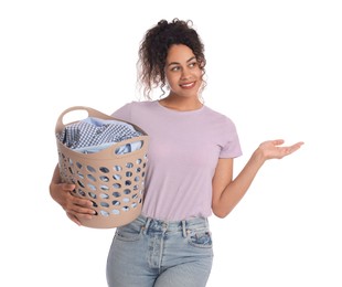 Photo of Happy woman with basket full of laundry on white background