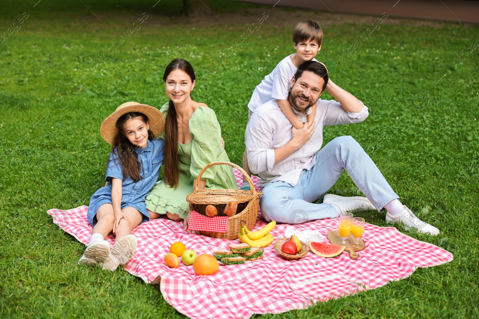 Photo of Happy family having picnic together in park