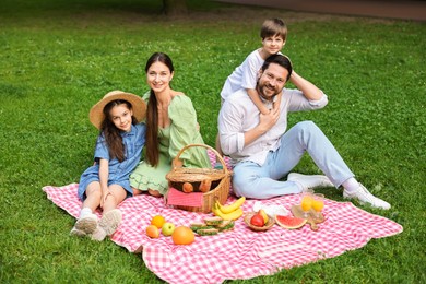 Happy family having picnic together in park